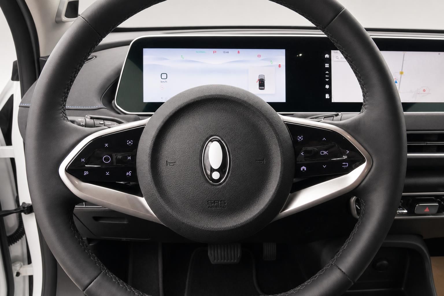 Lederlenkrad mit Bedienelementen und Kombiinstrument im Cockpit