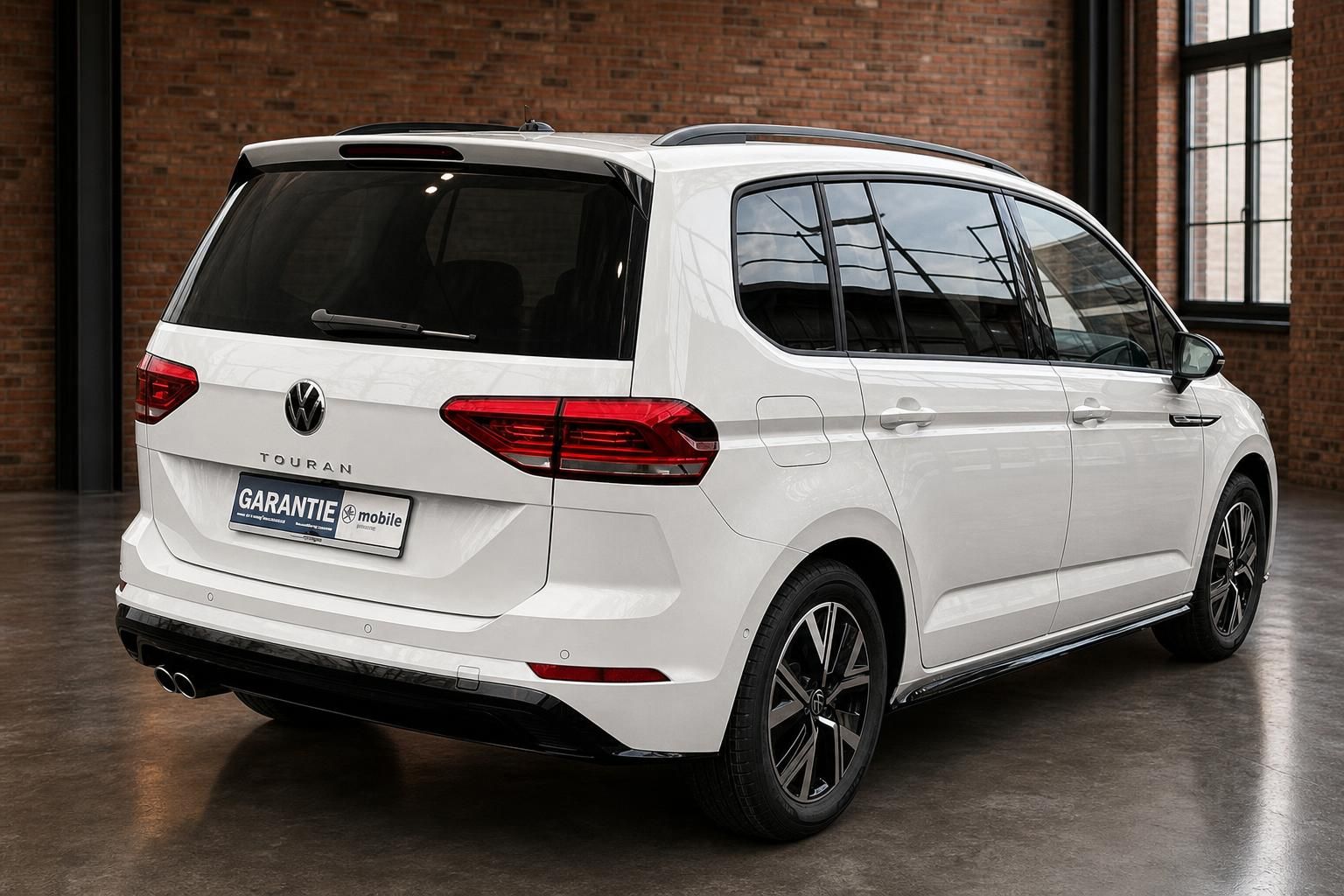 VW Touran weiss Heckansicht schraeg mit Alufelgen und Panoramadach