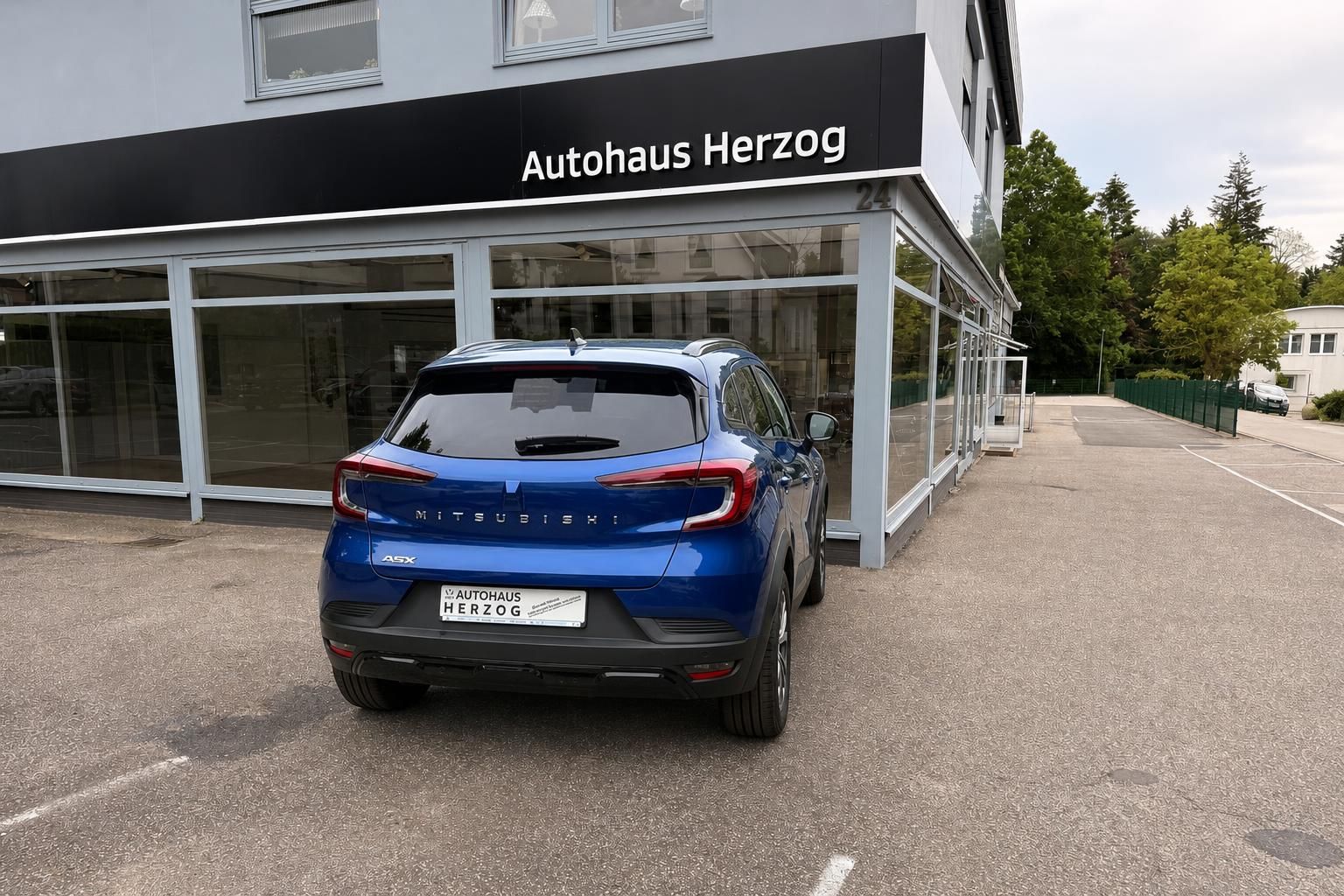 Mitsubishi ASX blau Heckansicht vor Autohaus Herzog - Kompakt-SUV gebraucht kaufen