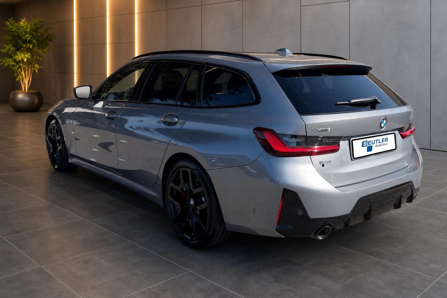 BMW 3er Touring xDrive silber, Heck-Seitenansicht mit schwarzen Felgen