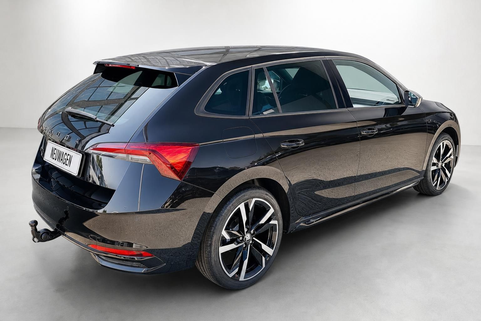 Skoda Scala schwarz Heck- und Seitenansicht mit Anhaengerkupplung