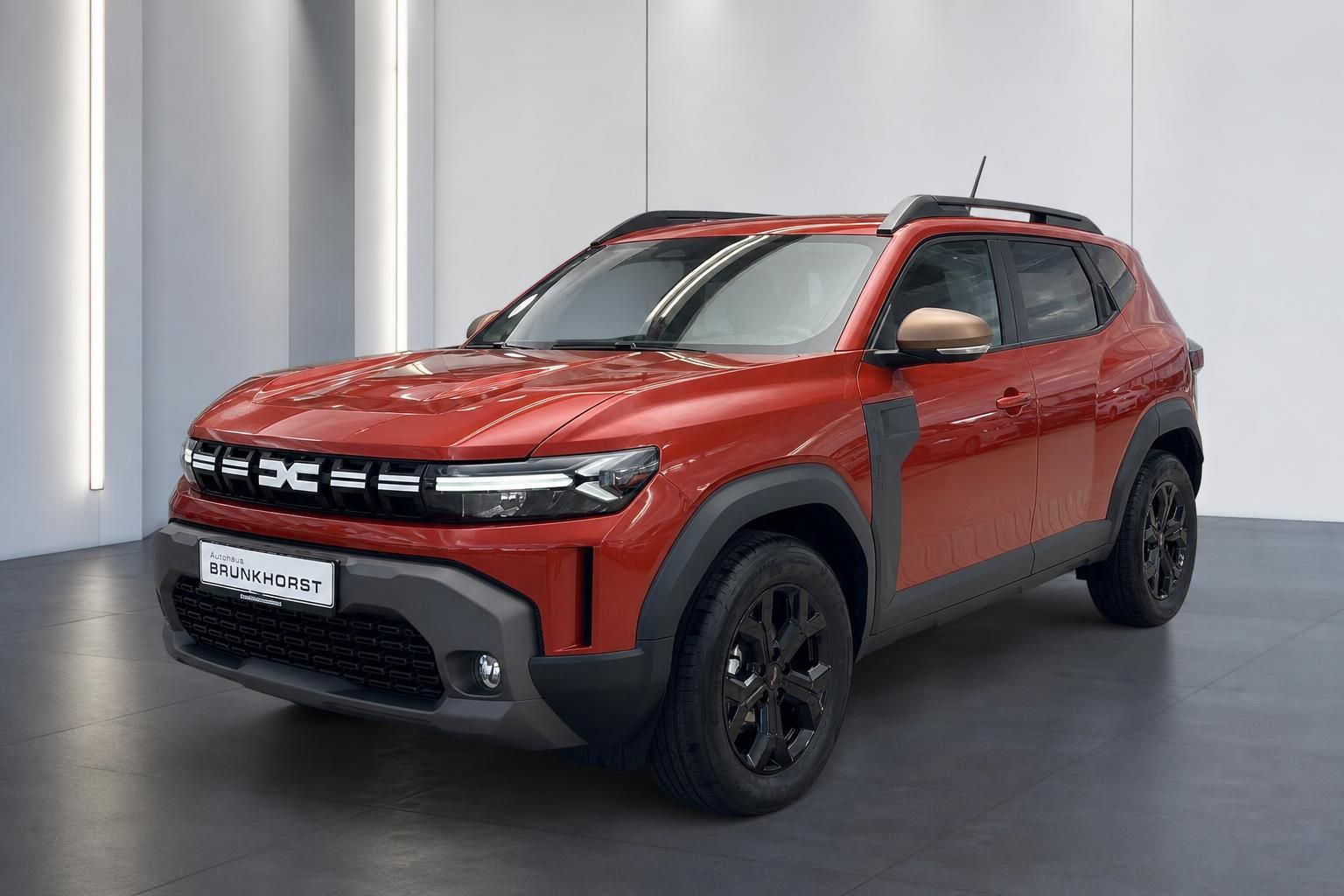 Dacia Duster SUV in rot - seitliche Dreiviertel-Ansicht mit schwarzen Felgen und Dachträgern