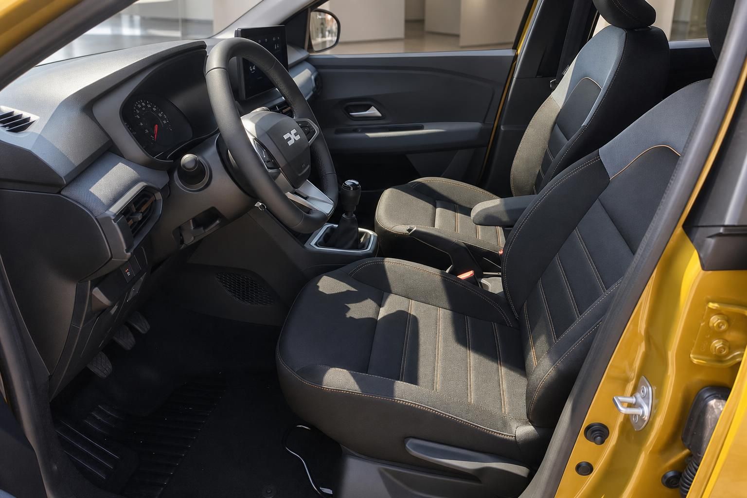 Dacia Vordersitze und Cockpit in gelbem Fahrzeug Innenraum