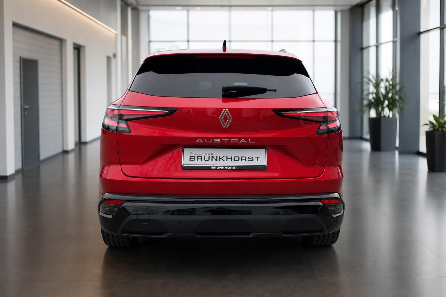 Roter Renault Austral Heckansicht im hellen Autohaus Showroom