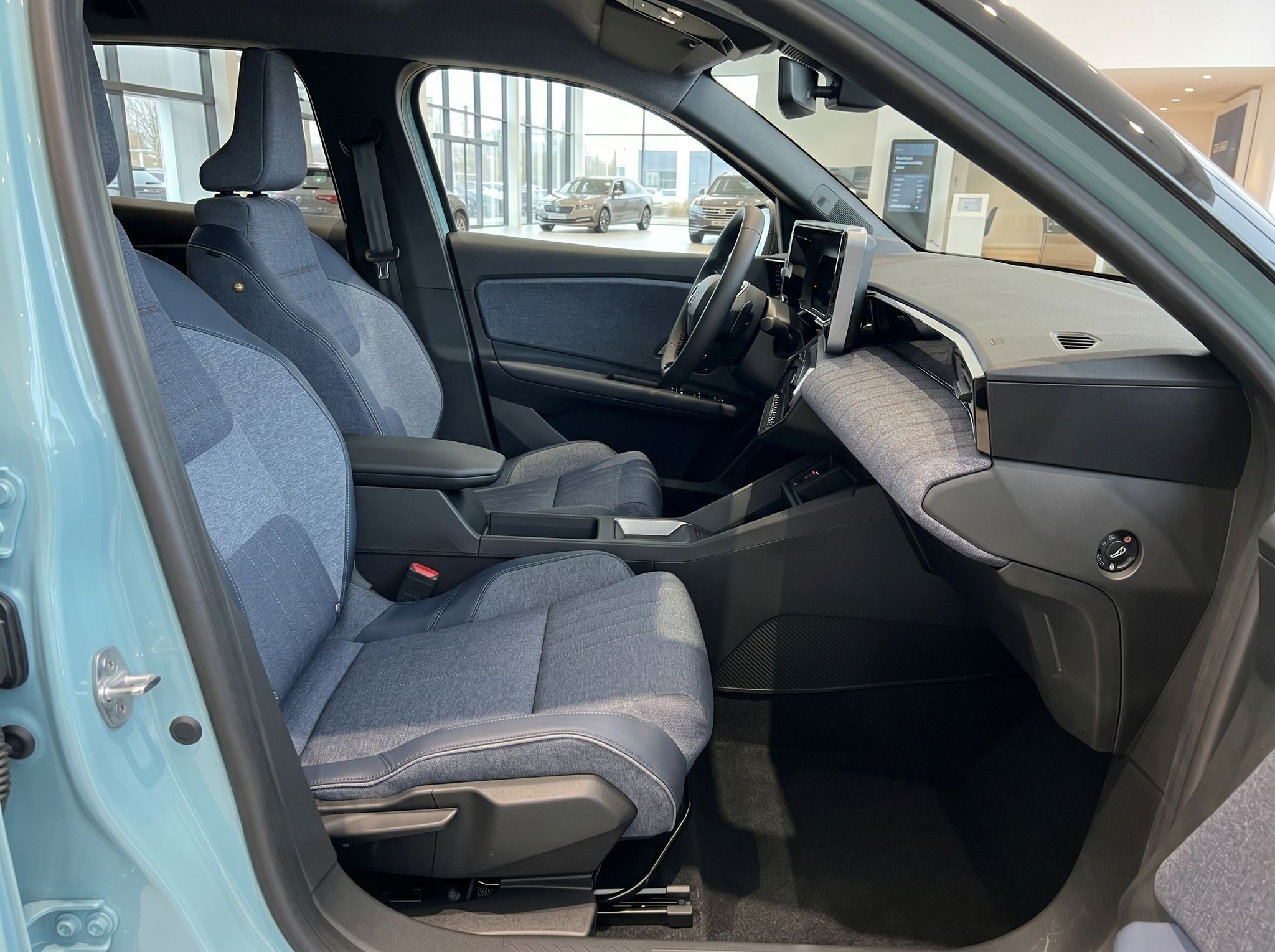 Fahrzeug Innenraum Beifahrerseite mit blauen Sitzen und modernem Dashboard im Autohaus