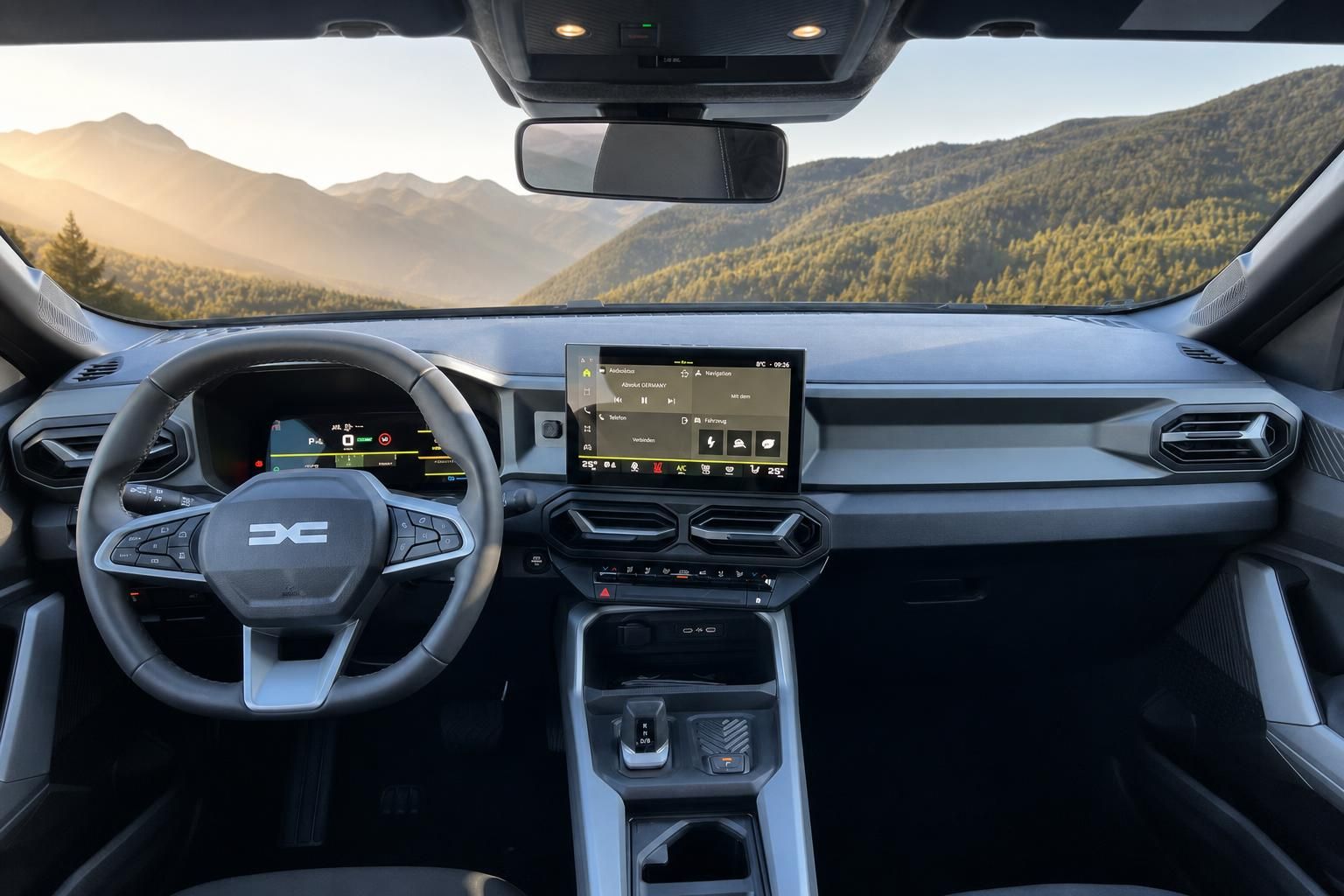 Dacia Bigster Innenraum Cockpit mit Touchscreen und Berglandschaft im Hintergrund