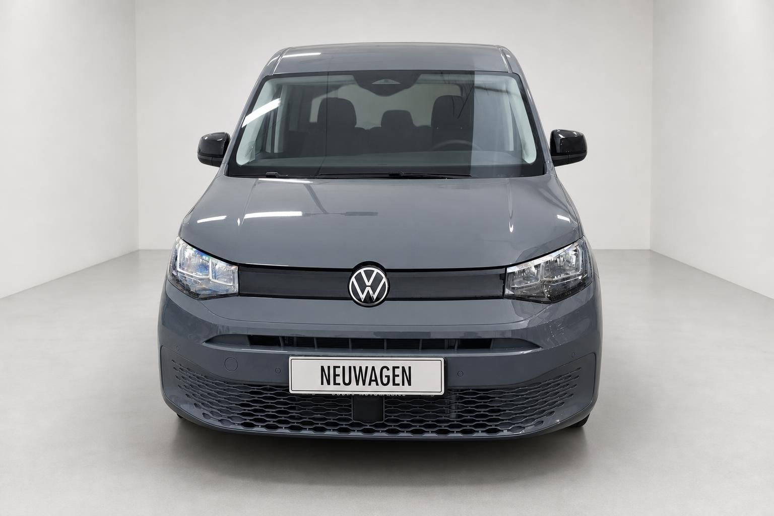 VW Caddy grau, direkte Frontansicht mit Kennzeichen