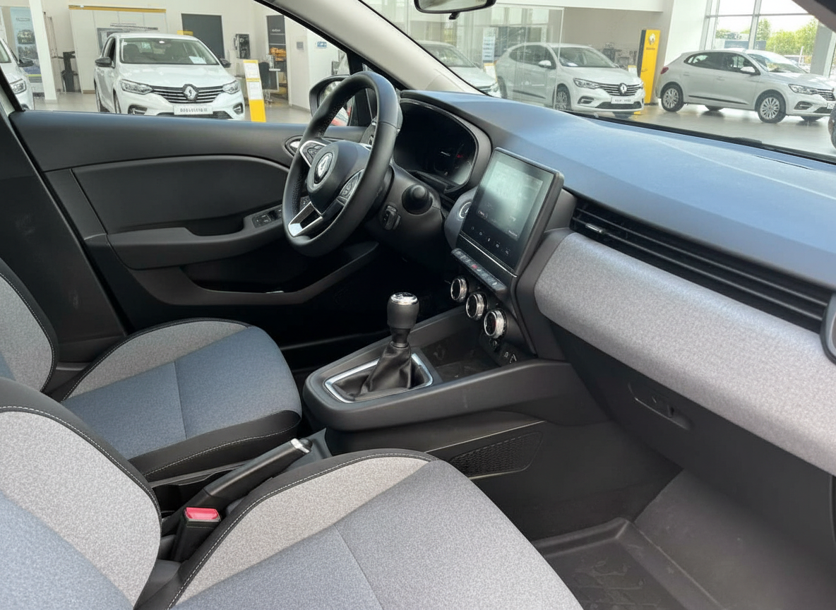 Renault Clio Innenraum mit Schaltgetriebe, Touchscreen und grauen Stoffsitzen im Autohaus