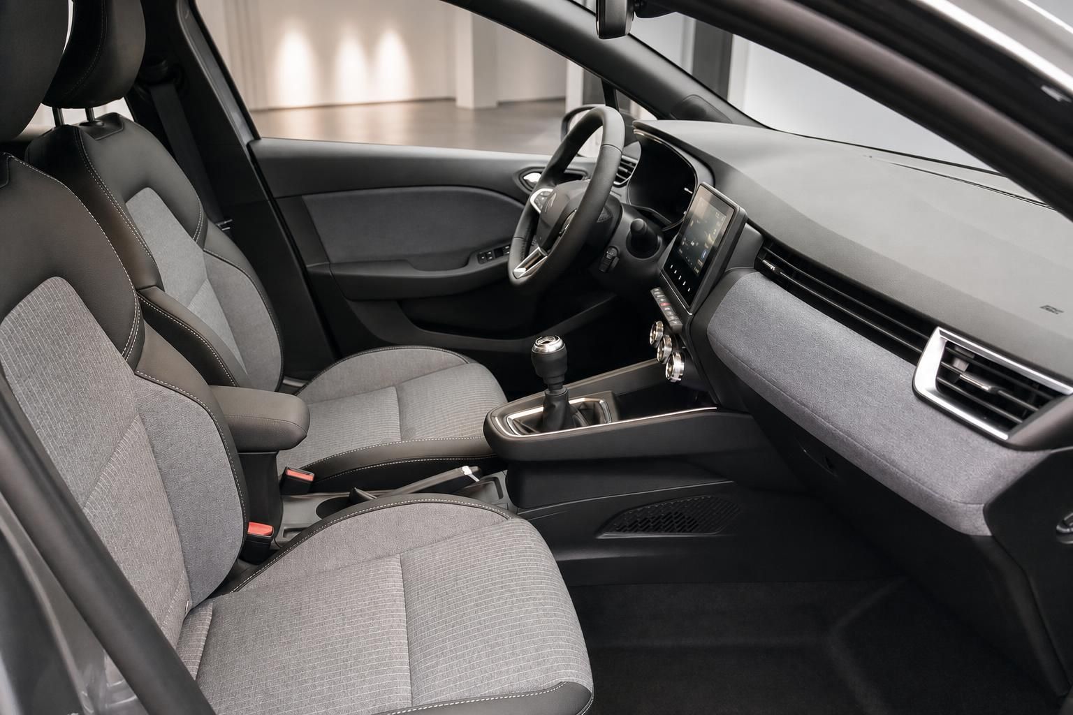 Fahrzeug Innenraum Vordersitze mit grauem Stoffbezug, Schaltgetriebe und Touchscreen-Infotainment