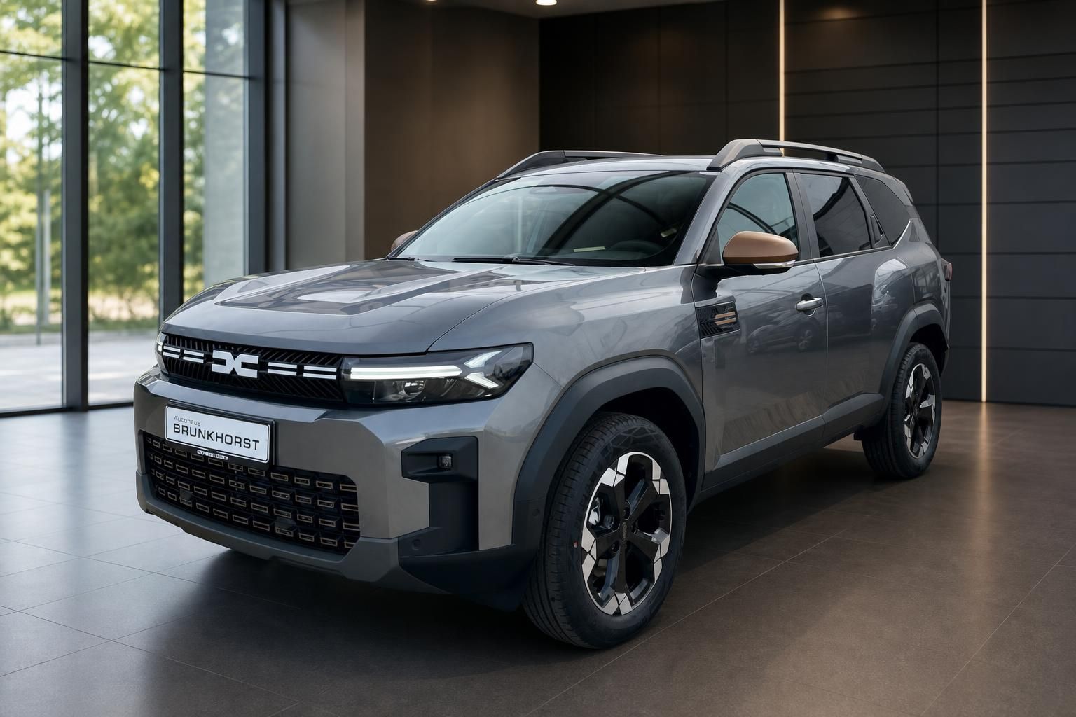 Dacia Bigster SUV in grau - Seitenansicht im Showroom mit modernem Design und Allradfelgen