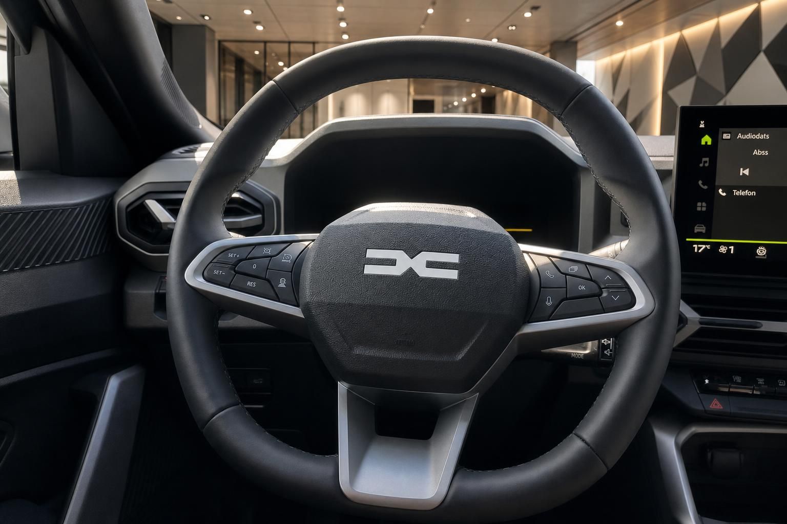 Lenkrad mit Bedienelementen und Multifunktionsdisplay im Fahrzeuginnenraum