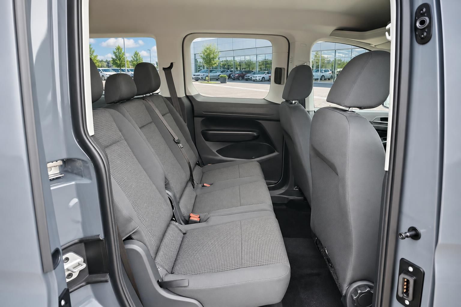 Rücksitzbank im Innenraum eines VW Vans mit Blick durch offene Schiebetür