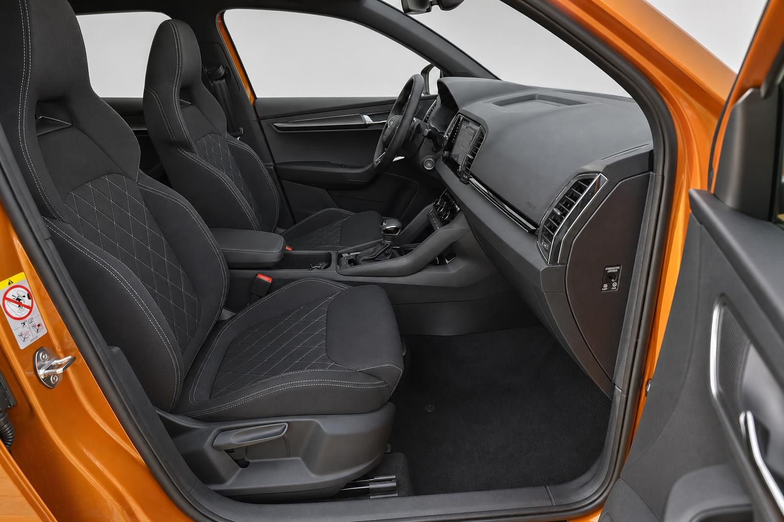 Innenraum Skoda Karoq mit schwarzen Sportsitzen und offener Fahrertür