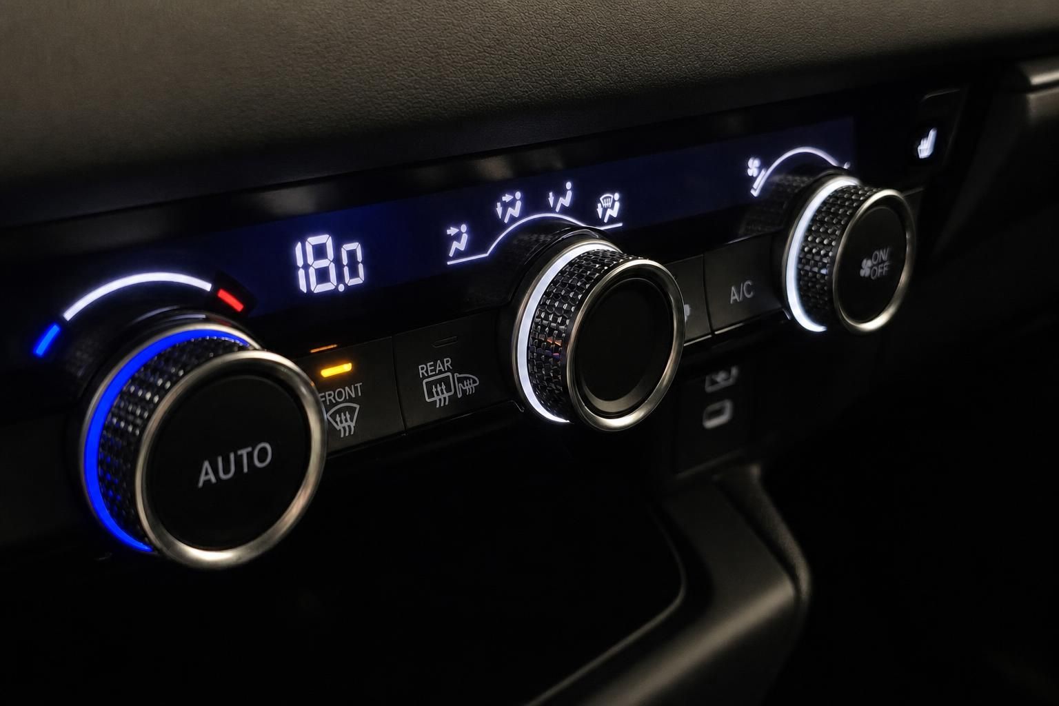 Klimabedienung im Honda Innenraum mit beleuchteten Drehreglern und Display