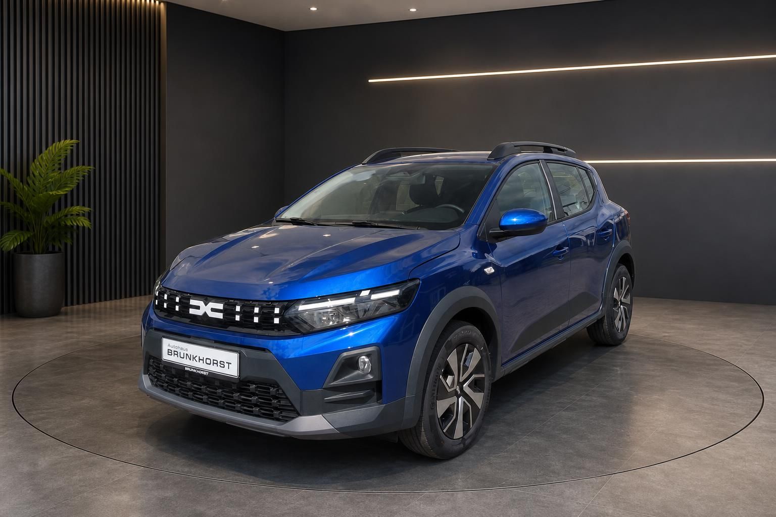 Blauer Dacia Sandero SUV in modernem Showroom mit Dachgepäckträger und schwarzen Kunststoffverkleidungen