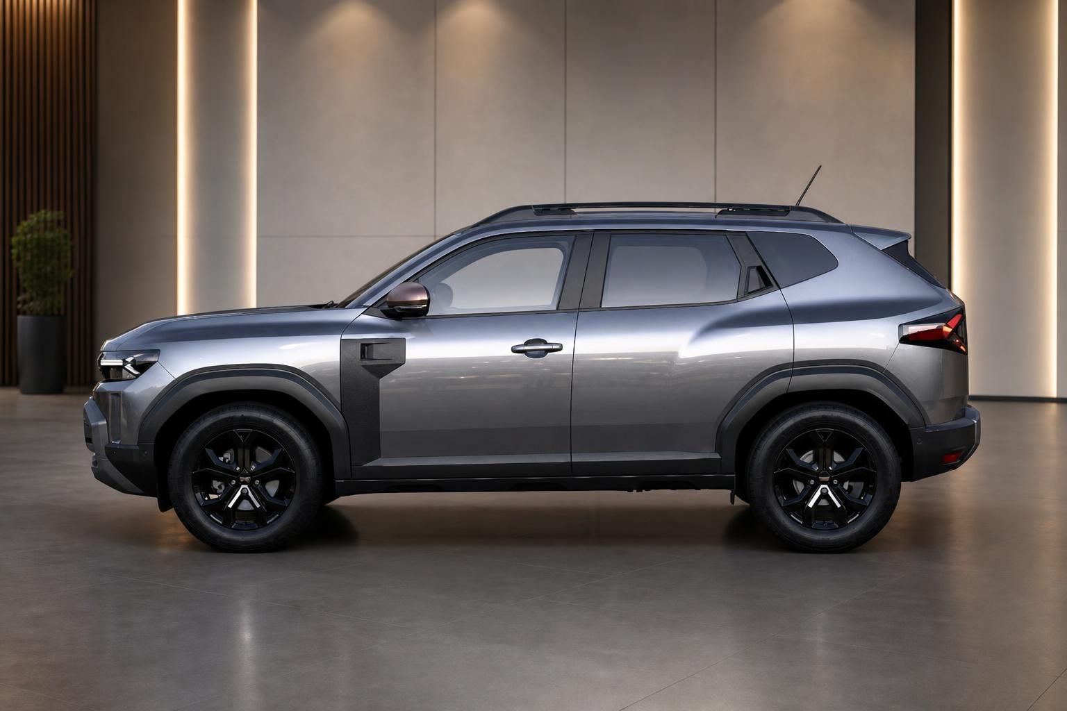 Dacia Duster SUV Seitenansicht links in grau mit schwarzen Felgen im Showroom