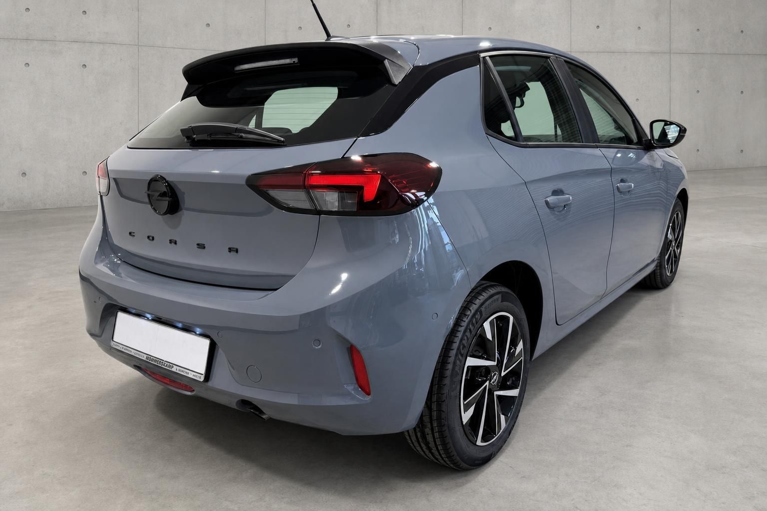 Opel Corsa Grau, Heckansicht schraeg von hinten im Studio