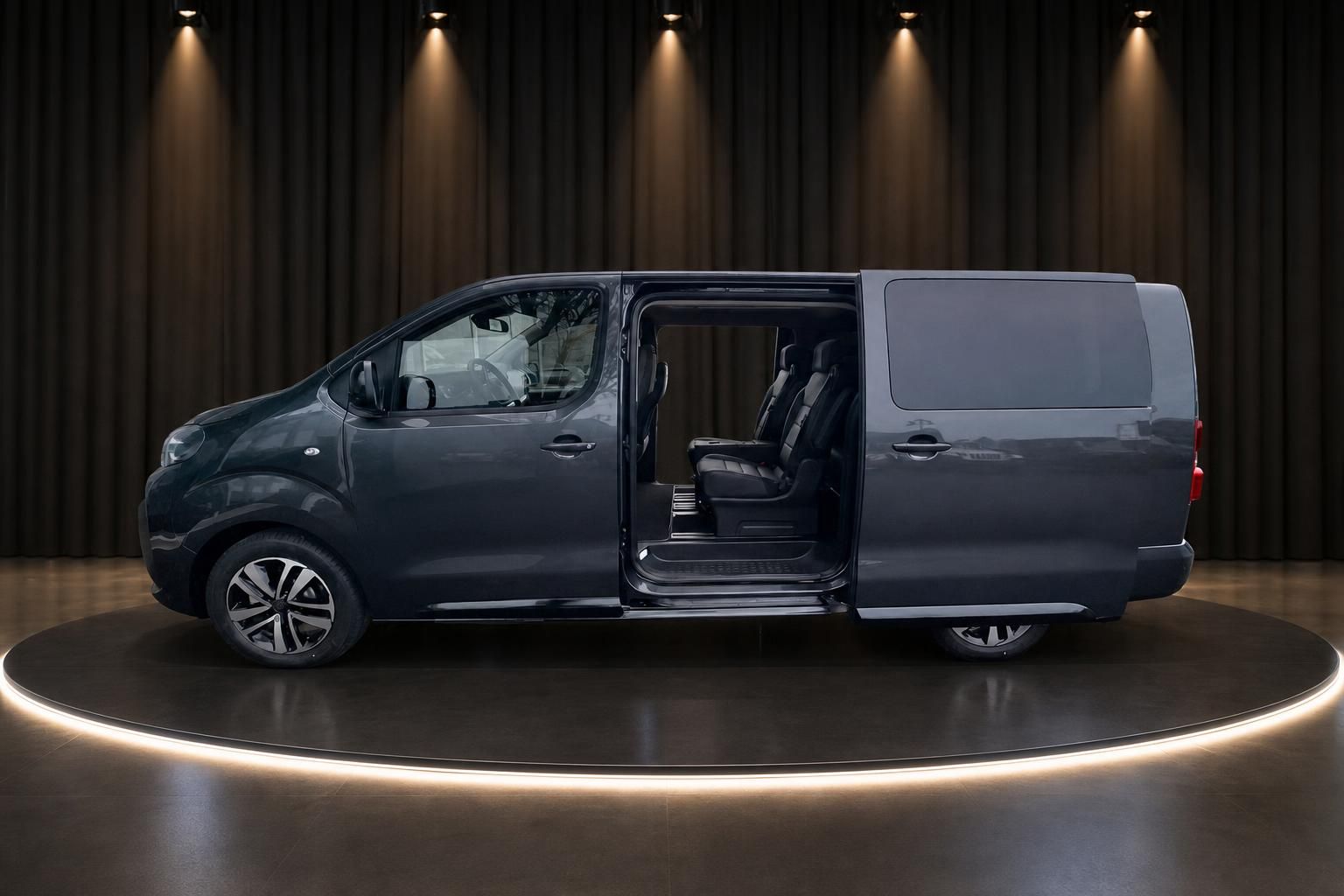 Kleinbus mit geöffneten Türen präsentiert Fahrgastraum in luxuriösem Showroom Ambiente