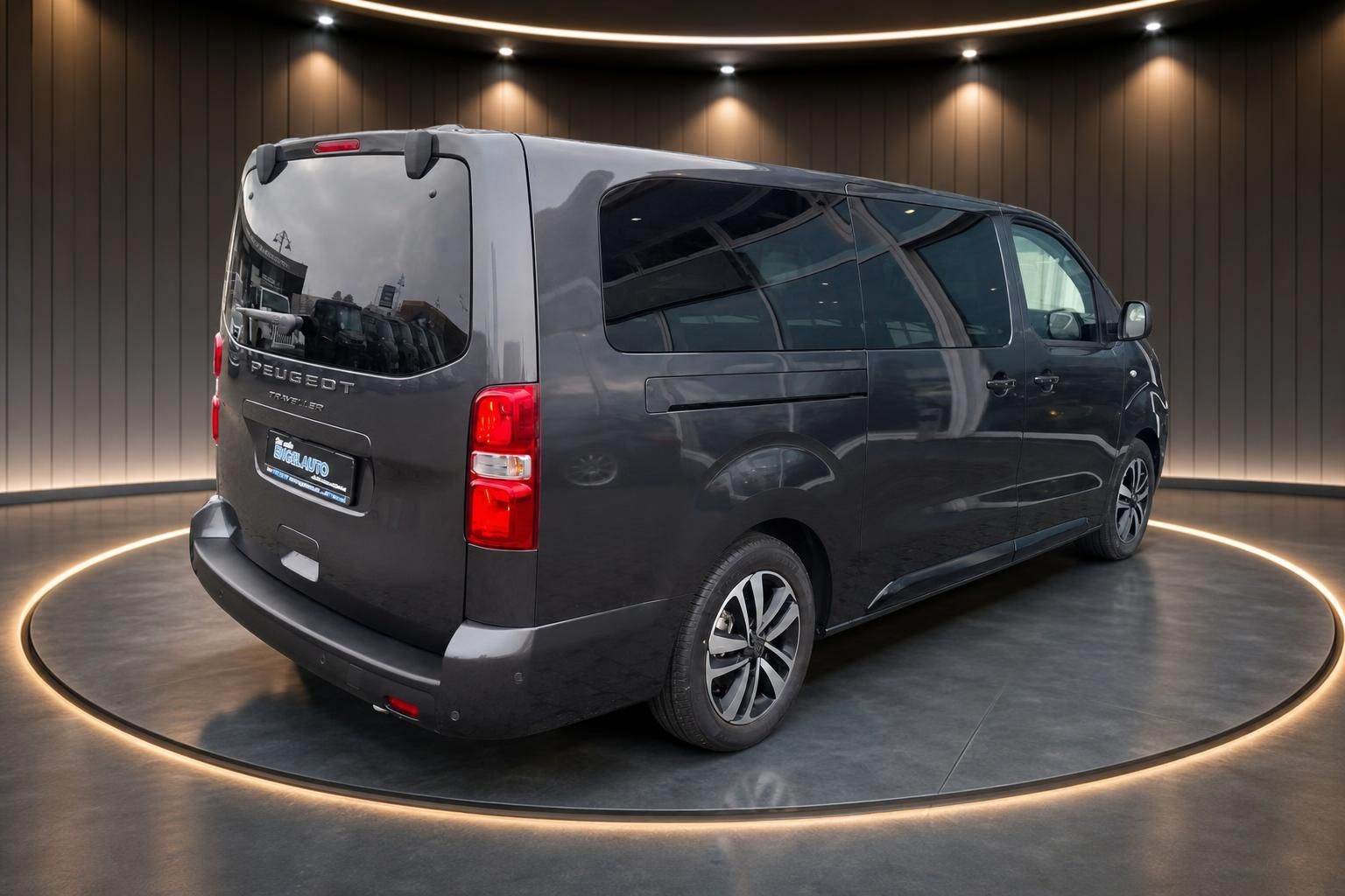 Peugeot Traveller grauer Kleinbus seitliche Heckansicht auf Drehbühne im Showroom