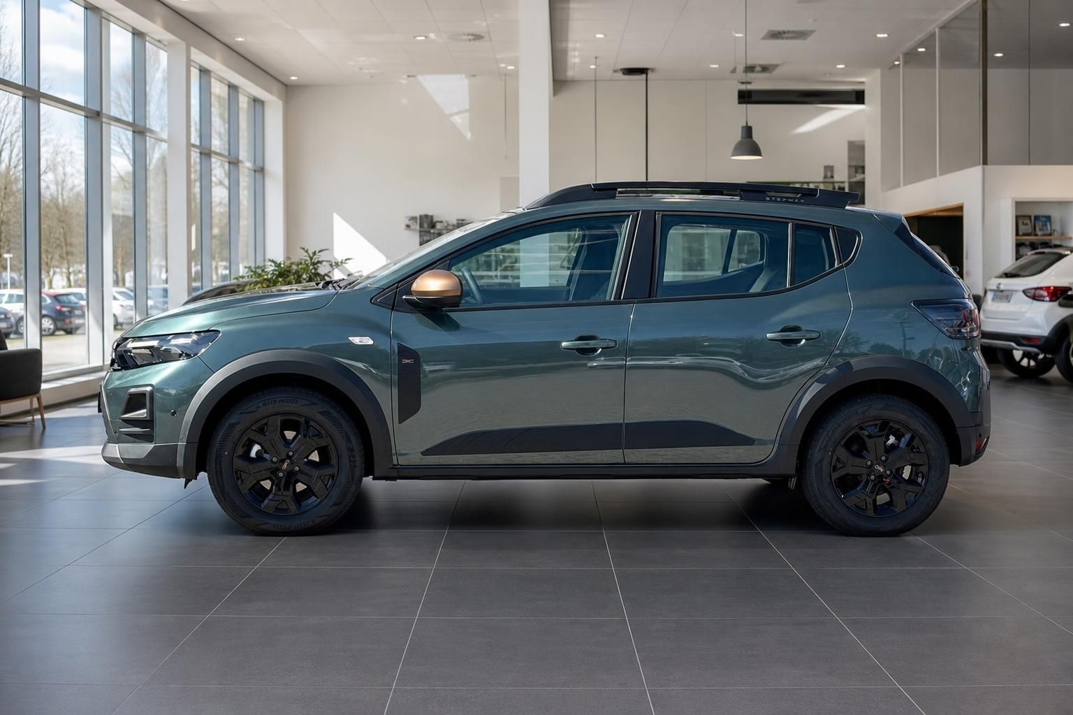 Dacia SUV Seitenansicht in graugrün mit schwarzen Felgen im Autohaus
