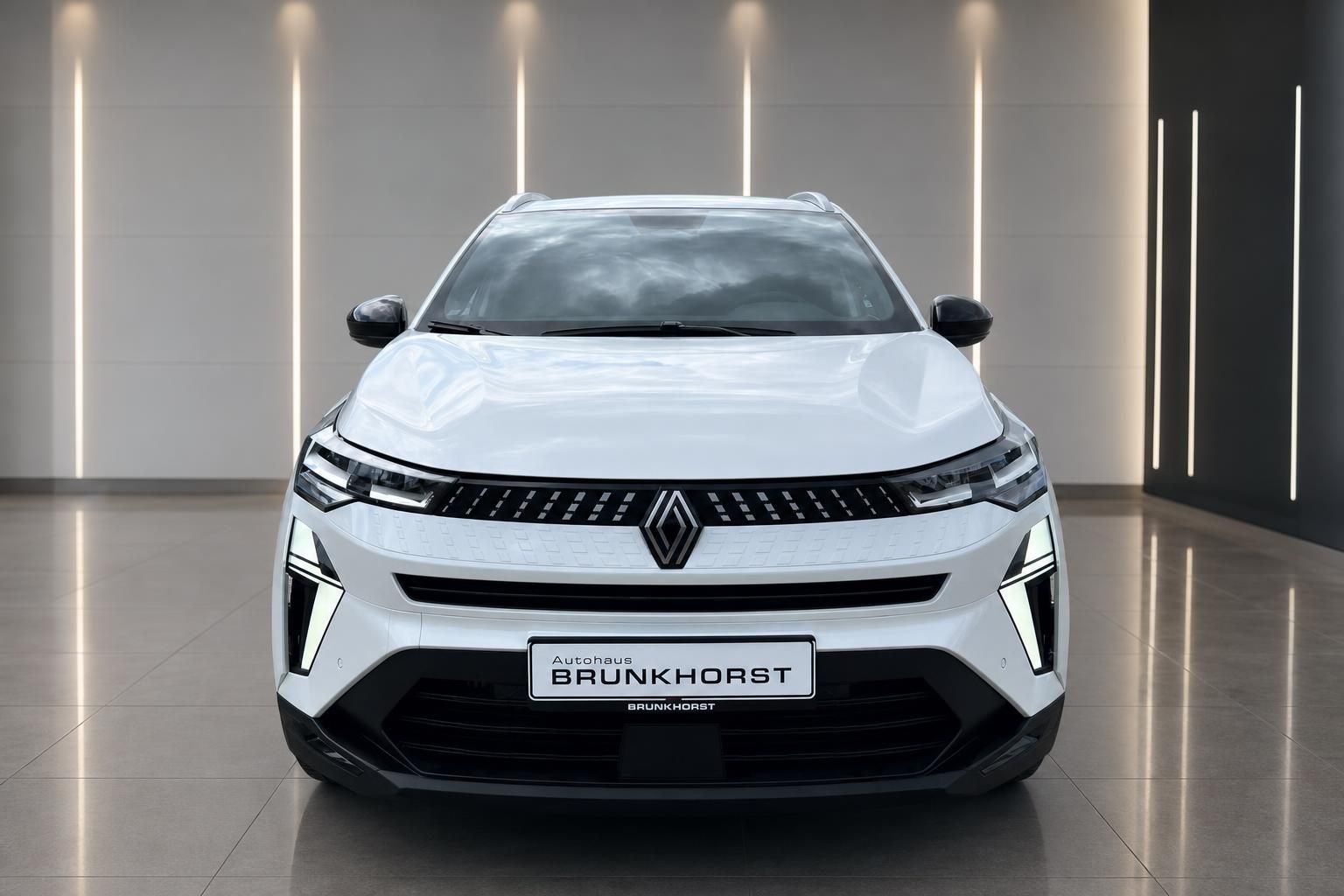 Weißer Renault Captur Frontansicht im modernen Autohaus-Showroom mit LED-Beleuchtung