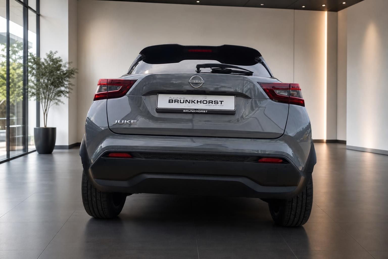 Nissan Juke SUV in Grau Heckansicht im modernen Autohaus Showroom