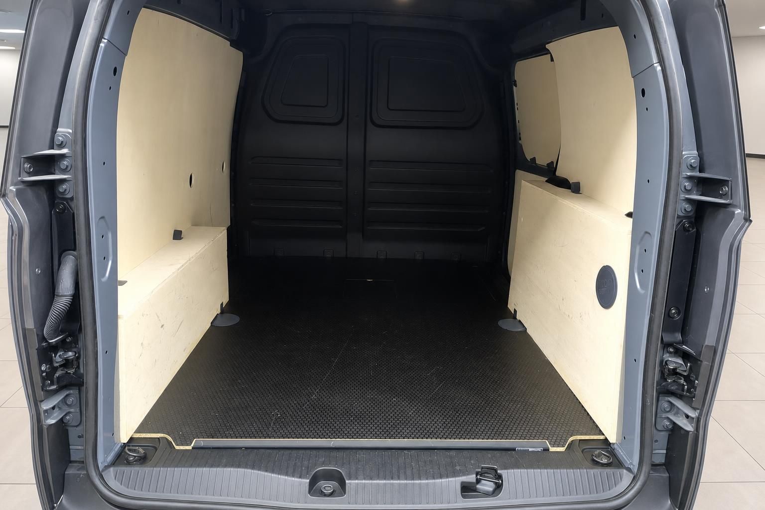 Laderaum eines Transporters mit beiger Verkleidung und schwarzem Gummiboden