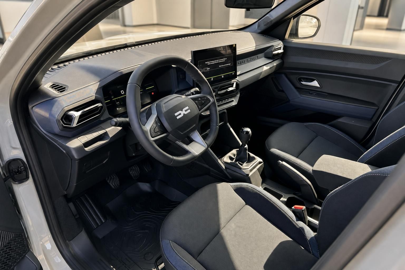 Dacia Duster Innenraum mit Fahrersitz, Lenkrad und Schaltknauf