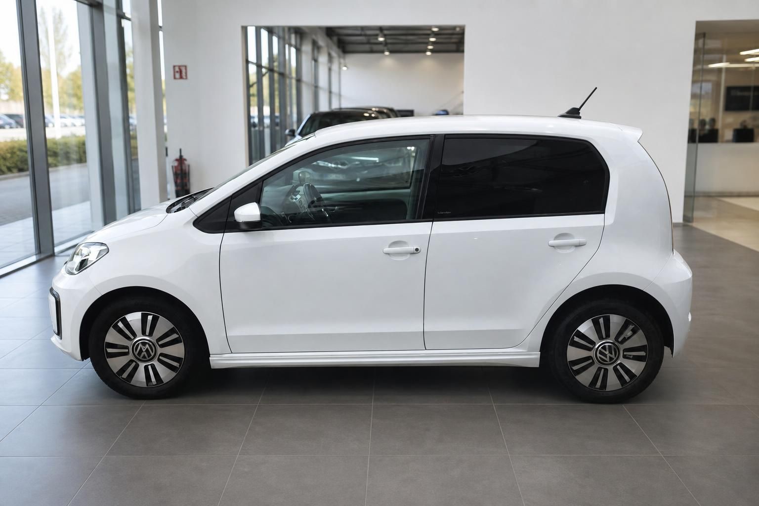 VW e-up! weiss Seitenansicht links im Autohaus Showroom