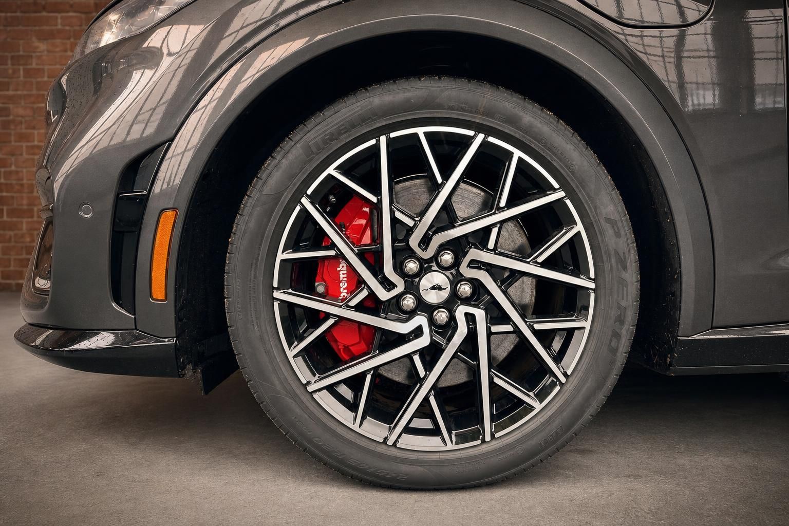 Nahaufnahme Leichtmetallfelge mit roter Brembo-Bremssattel am Fahrzeug