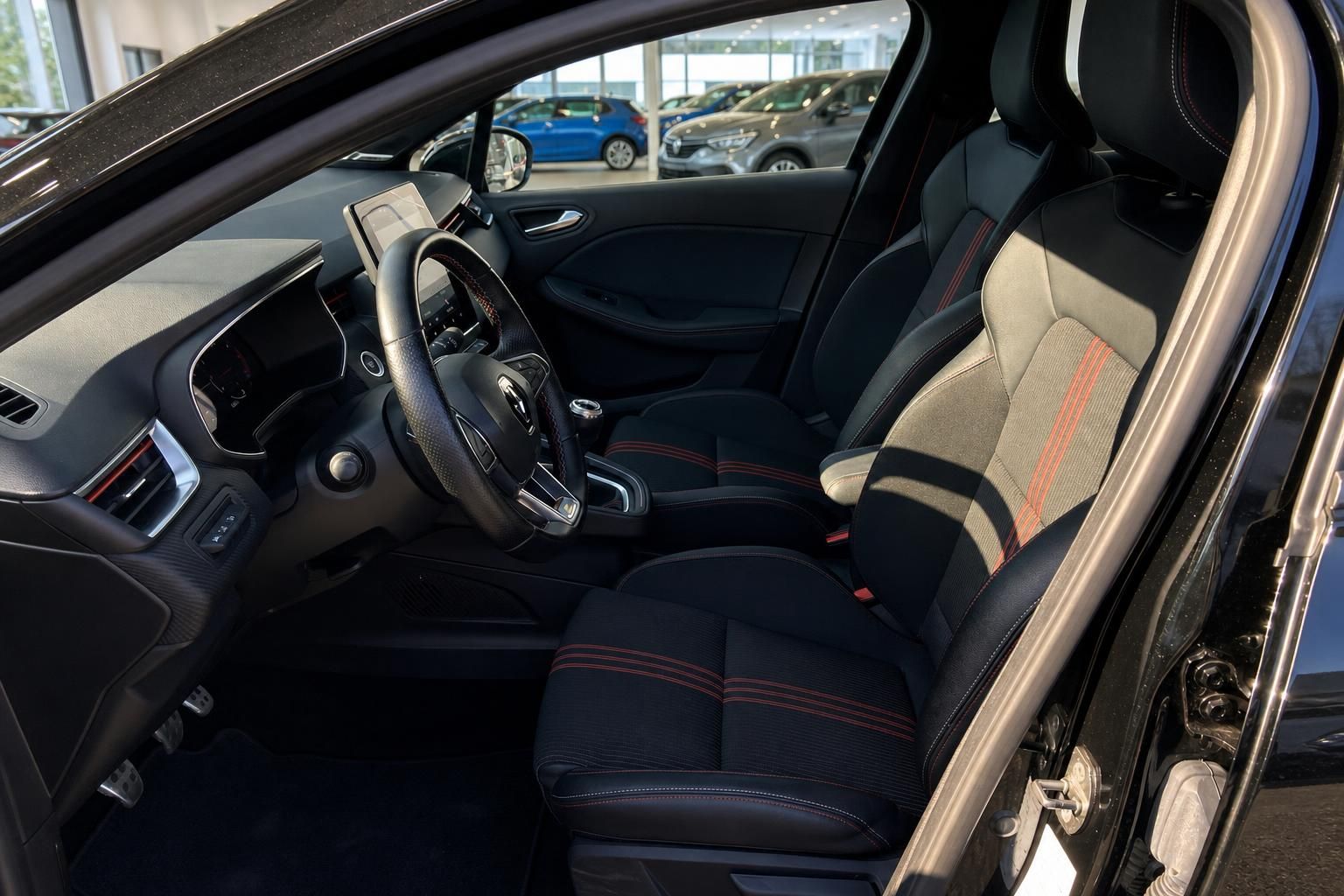 Renault Clio Fahrerseite Innenraum mit Sportsitzen, rotem Zierstich und Lenkrad