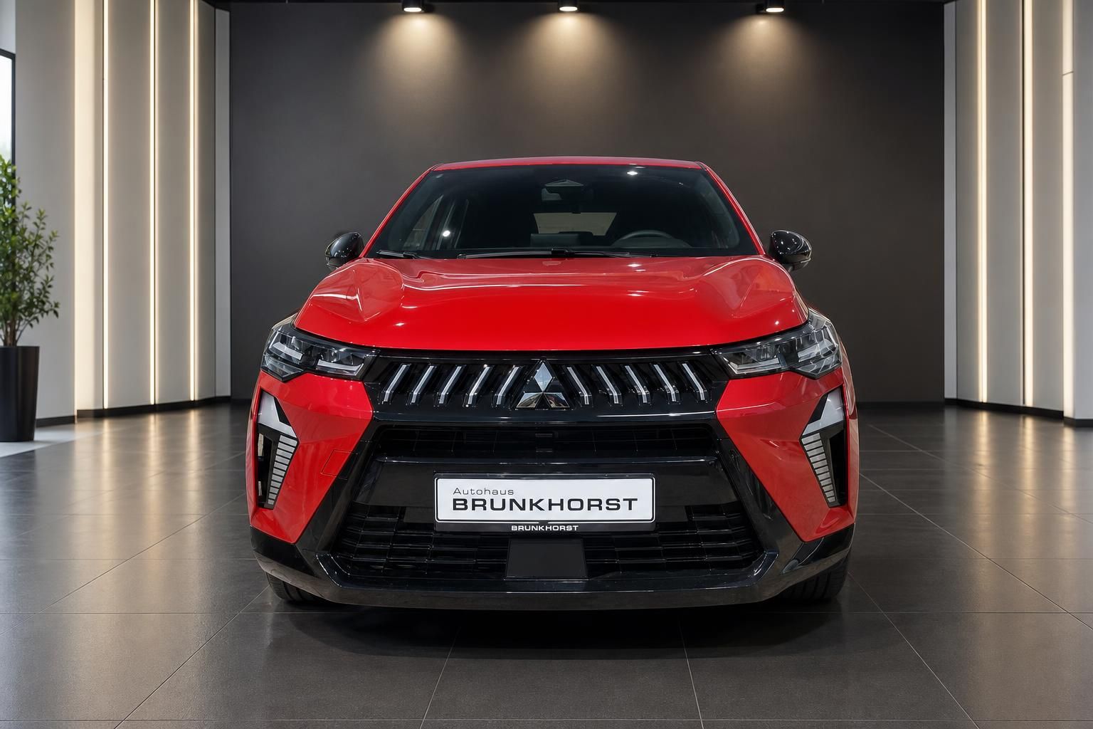 Frontansicht roter Mitsubishi SUV mit charakteristischem Kühlergrill im Autohaus Brunkhorst