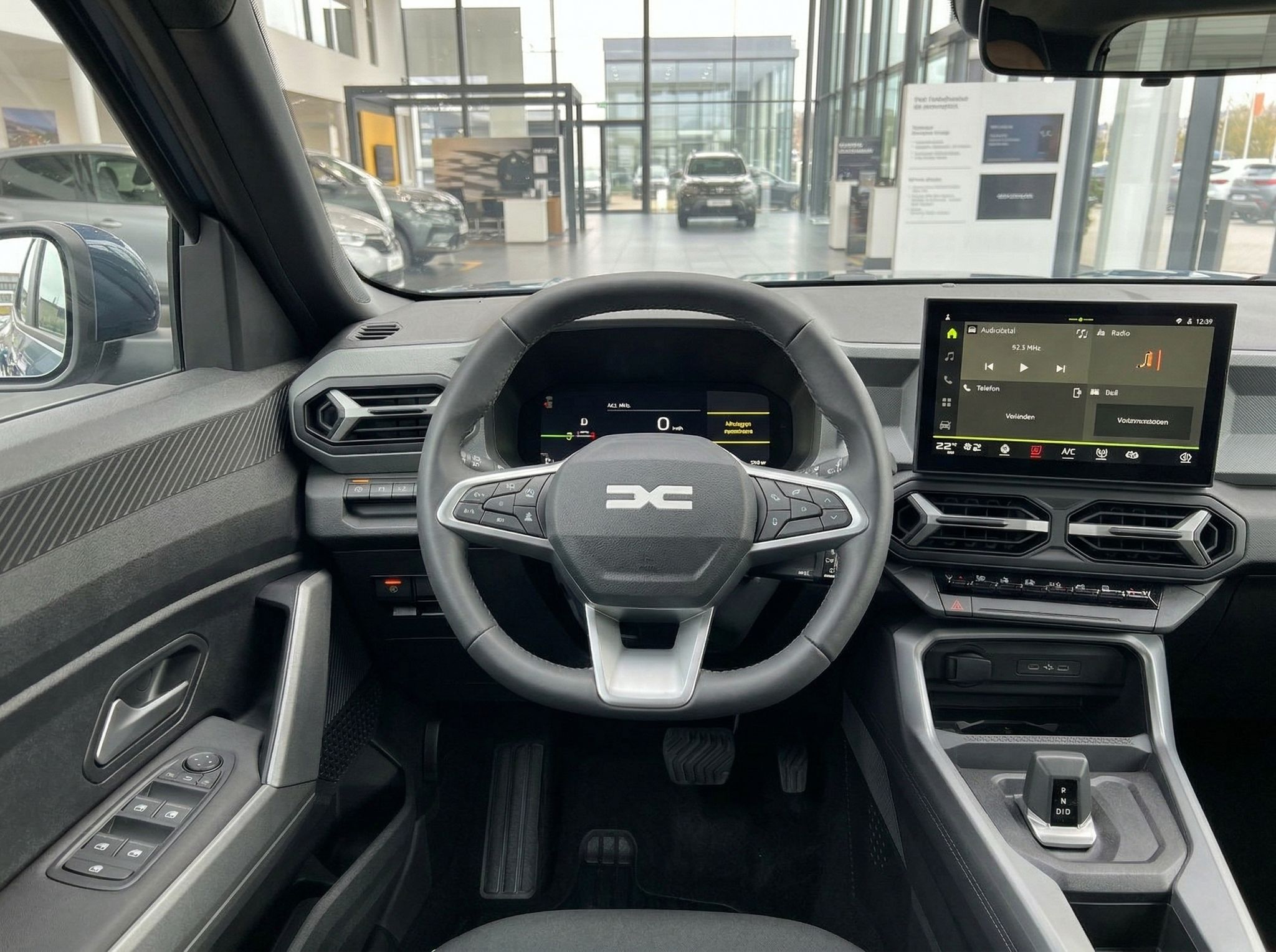 Dacia Fahrzeug Innenausstattung mit Lenkrad, digitalem Display und Mittelkonsole - Cockpit-Detail