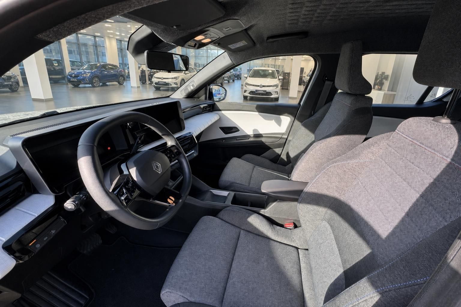 Innenraum eines Renault Fahrzeugs mit grauem Stoff-Interieur und Lenkrad