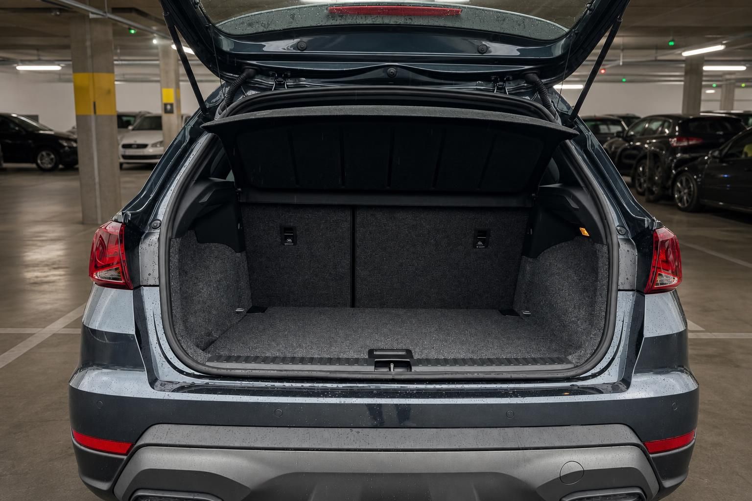 SEAT SUV grau mit geöffnetem Kofferraum zeigt großes Ladevolumen im Parkhaus