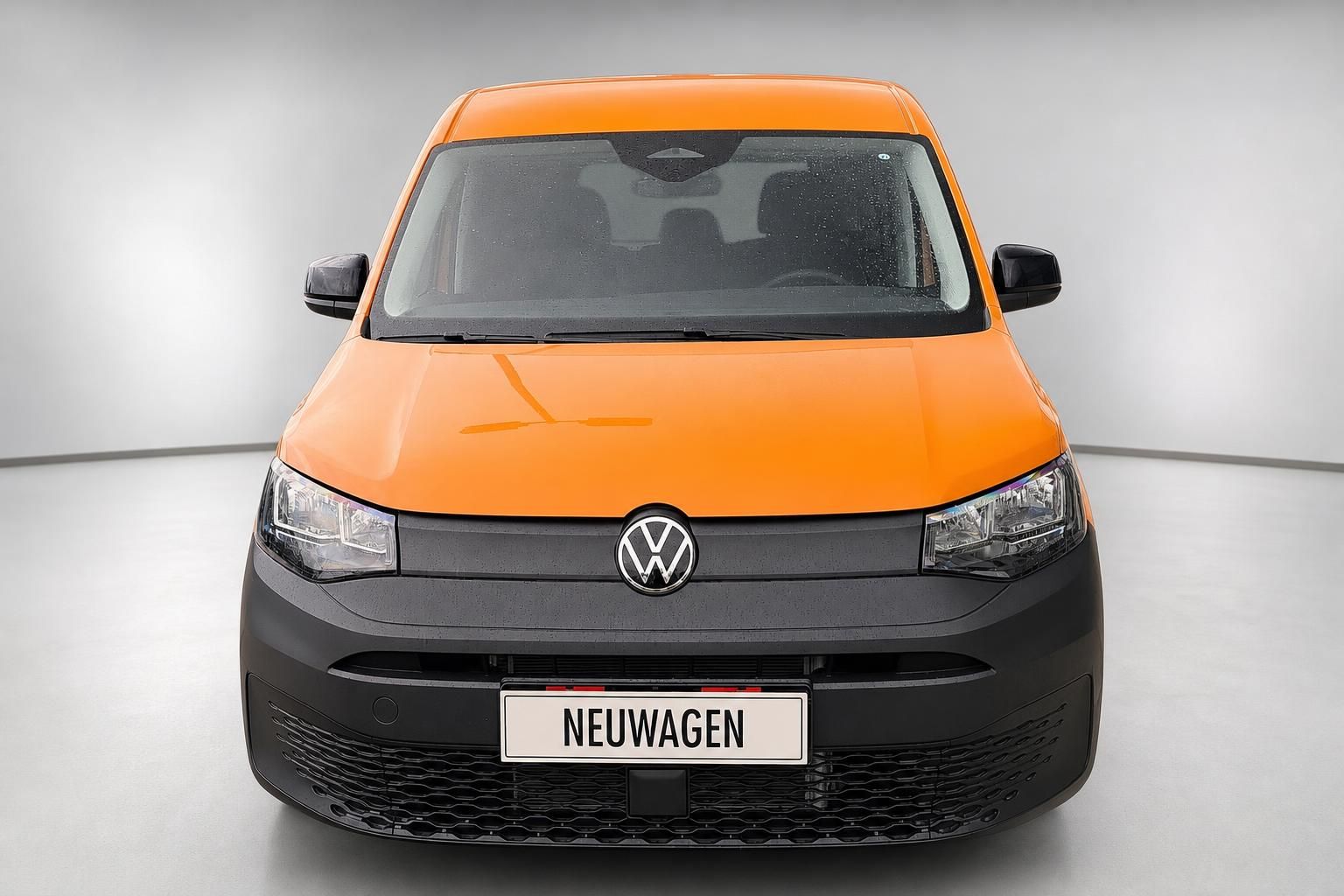 VW Caddy orange, Frontalansicht mit Kennzeichen Neuwagen