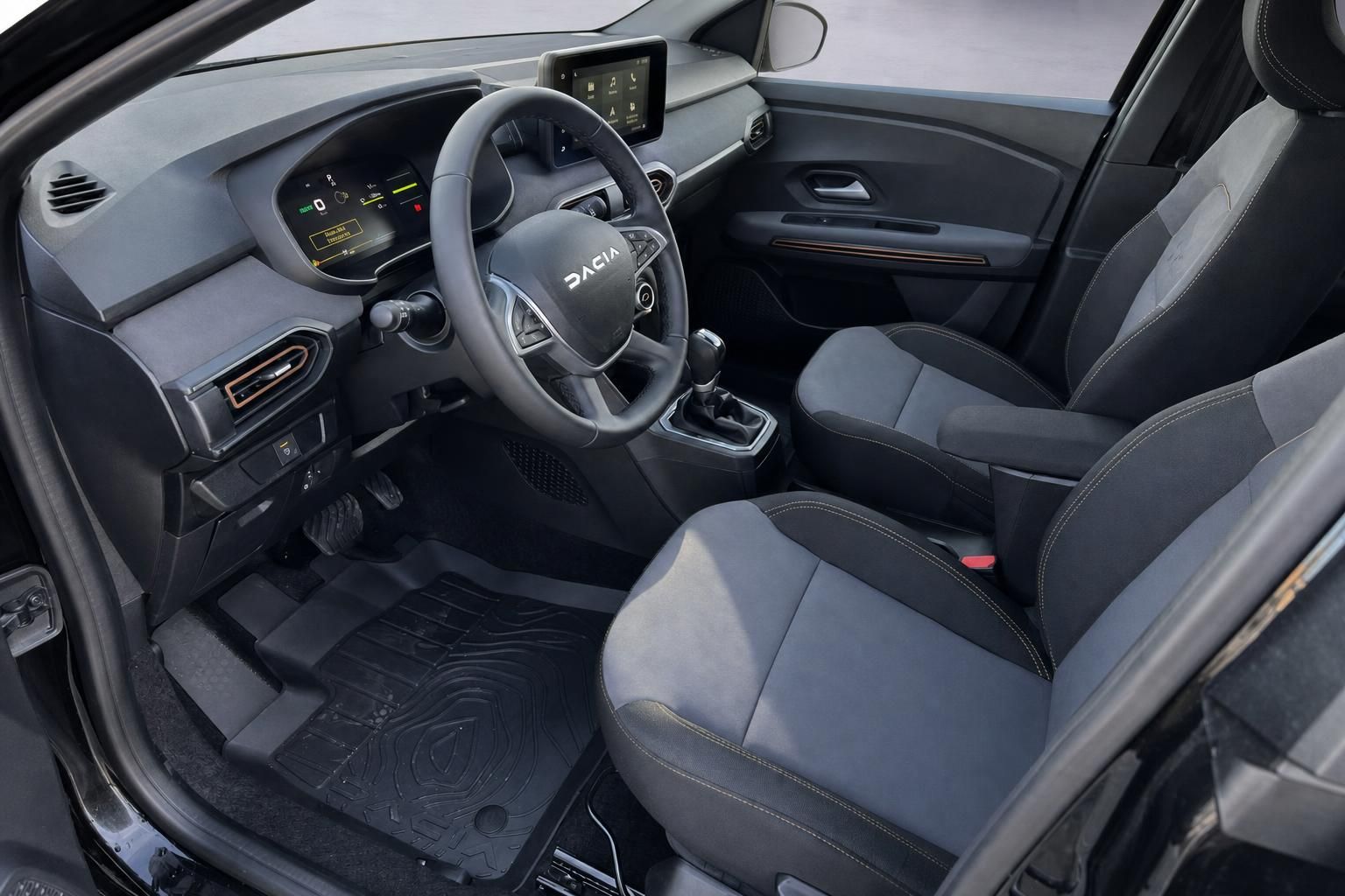 Dacia Fahrerplatz mit Armaturenbrett, Touchscreen und komfortablen Sitzen in Grau