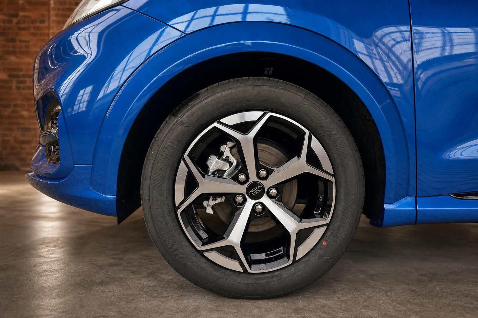 Detailansicht Leichtmetallfelge und Bremssattel des blauen Ford Puma ST