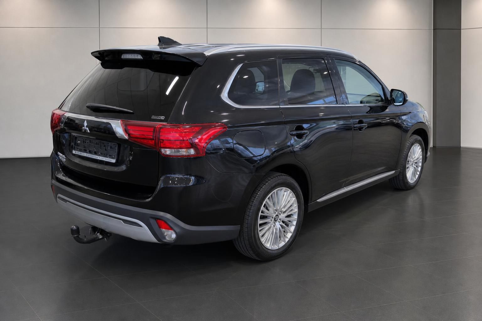 Mitsubishi Outlander PHEV schwarz, Heckansicht seitlich im Autohaus