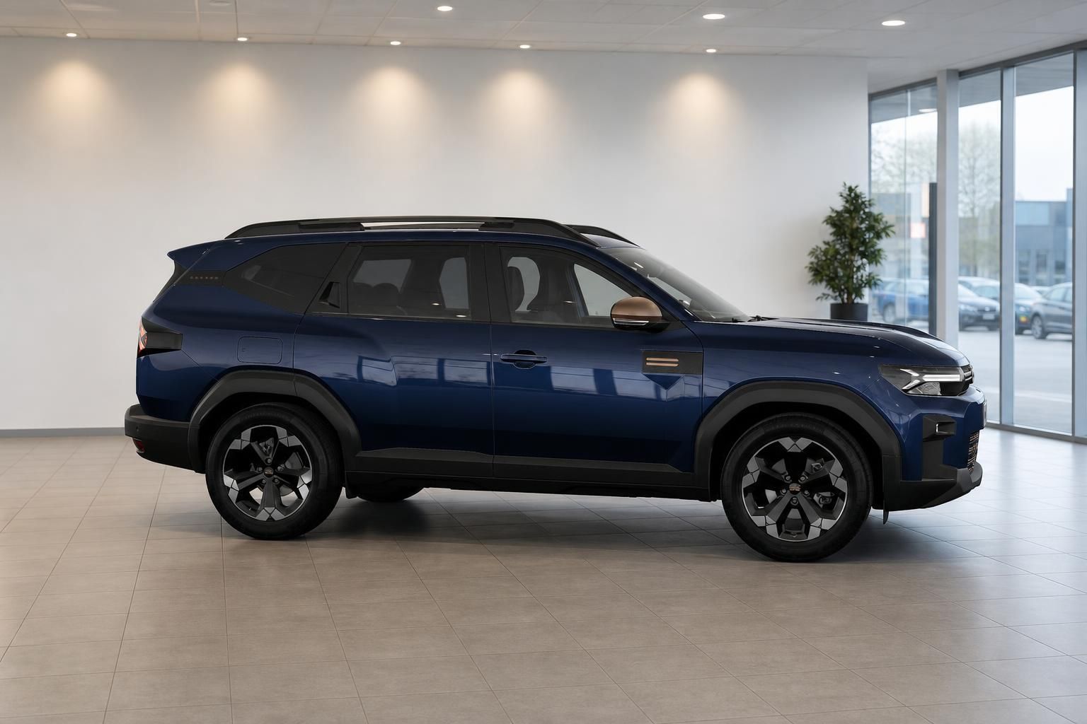 Dacia Bigster in Blau, Seitenprofil im modernen Autohaus