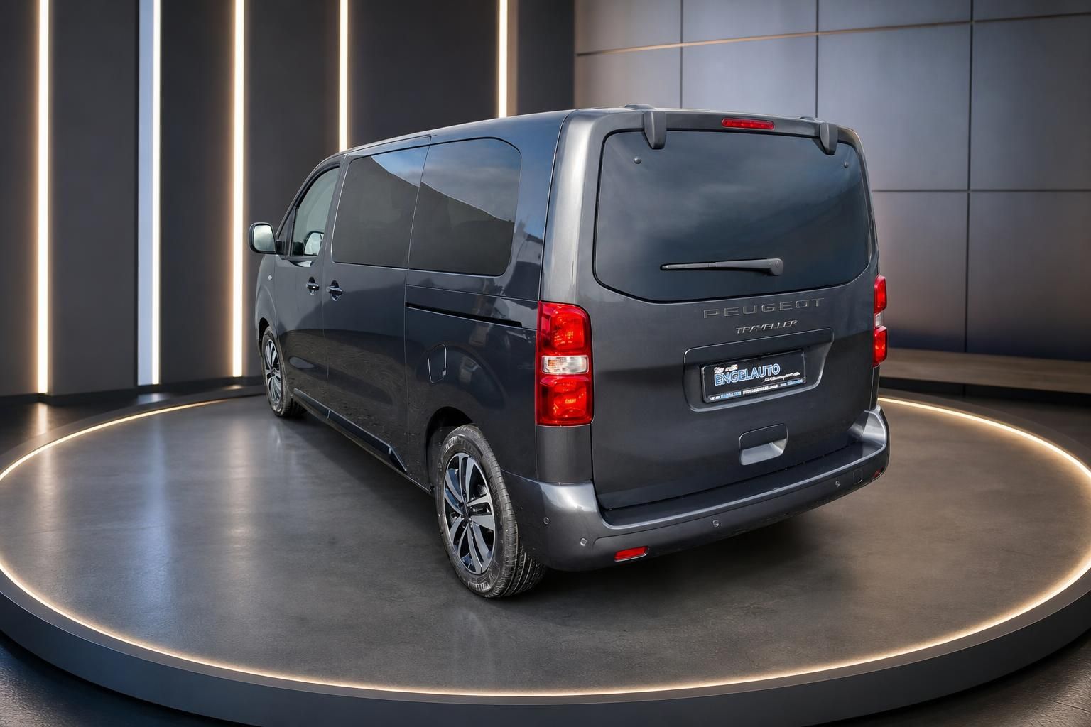Peugeot Traveller schräge Heckansicht grau mit Leichtmetallfelgen im modernen Showroom