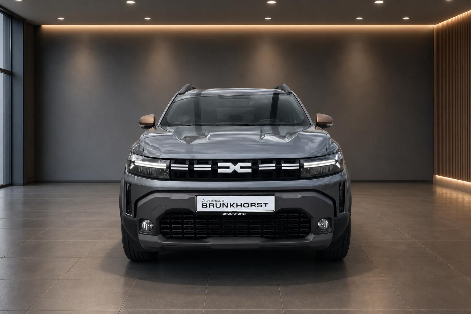 Dacia Duster SUV grau Frontansicht mit DC Logo im Autohaus Brünkhorst