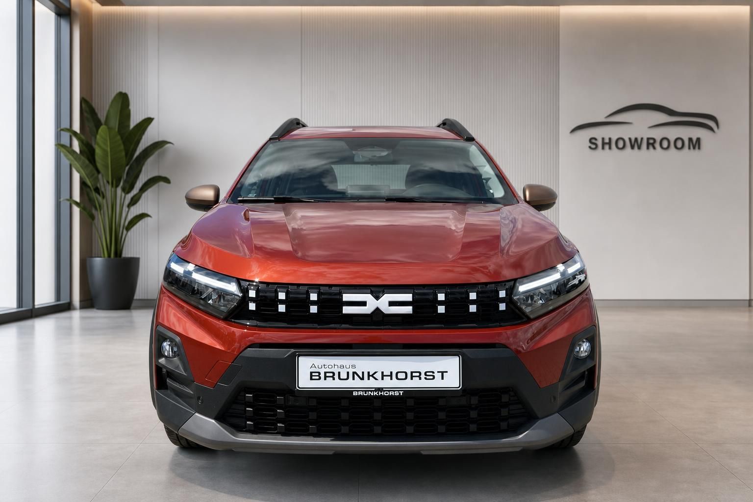 Roter Dacia SUV Frontansicht im Autohaus Showroom mit modernem LED-Design und schwarzen Akzenten