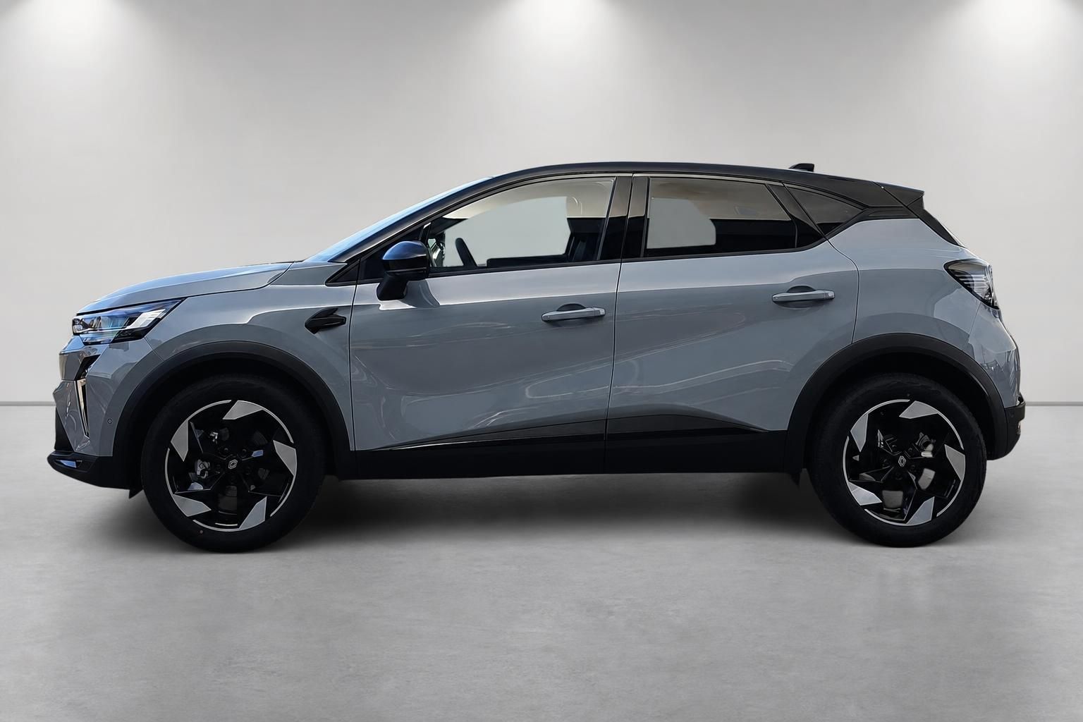 Renault Captur Seitenansicht in Grau mit schwarzem Dach und Alufelgen
