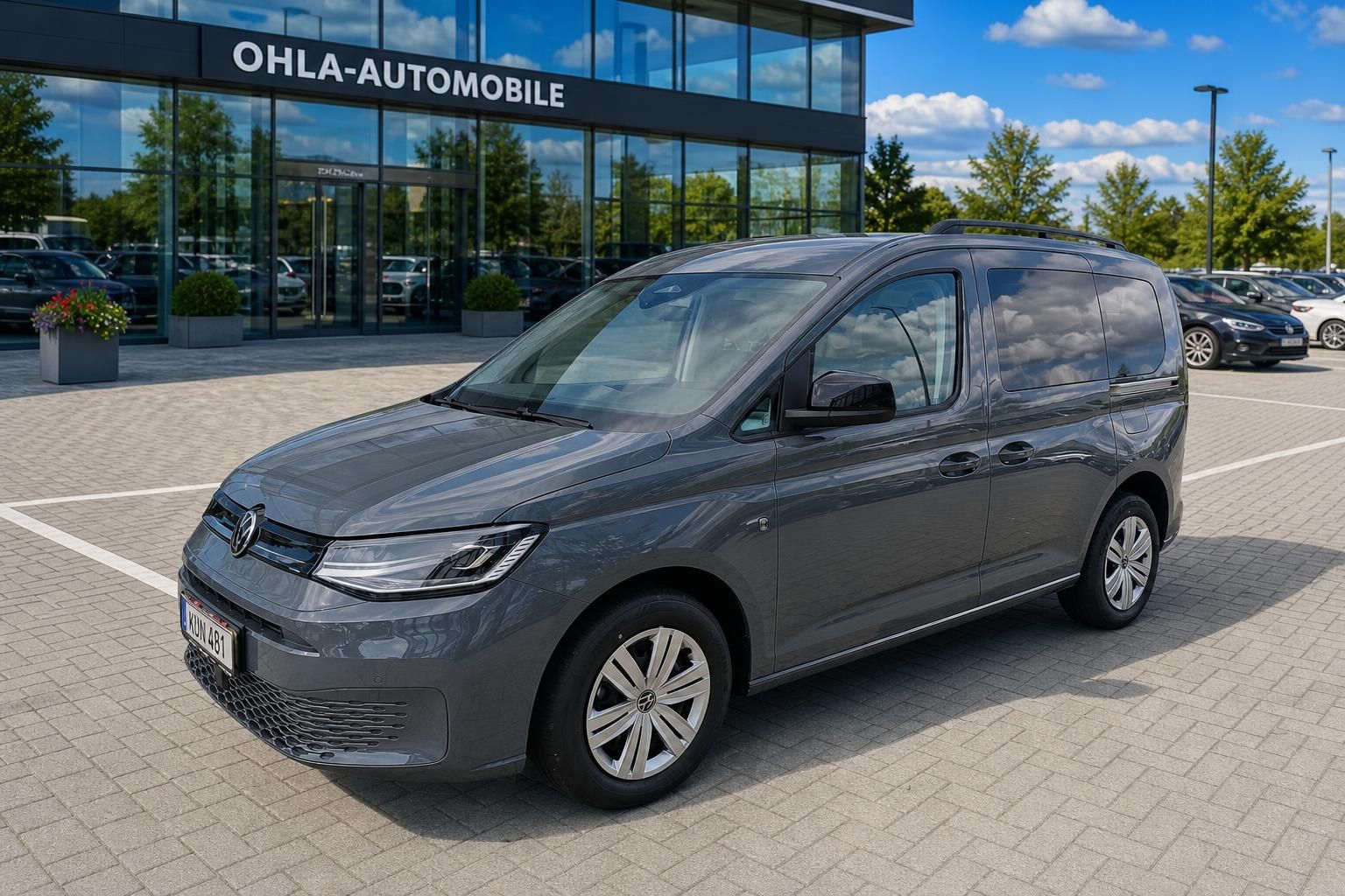 VW Caddy dunkelgrau Frontansicht vor Ohla-Automobile Autohaus