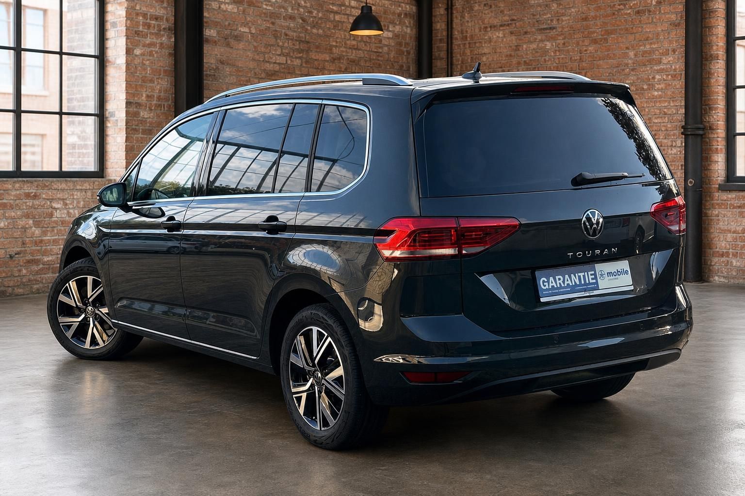 VW Touran schwarz Heckansicht seitlich in Backstein-Showroom