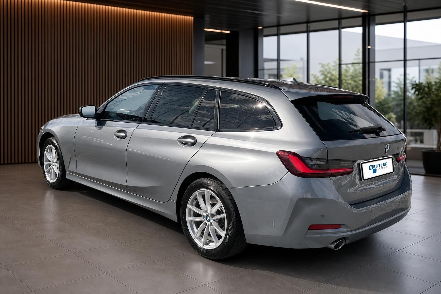 BMW 3er Touring grau, Heckansicht schraeg im Showroom