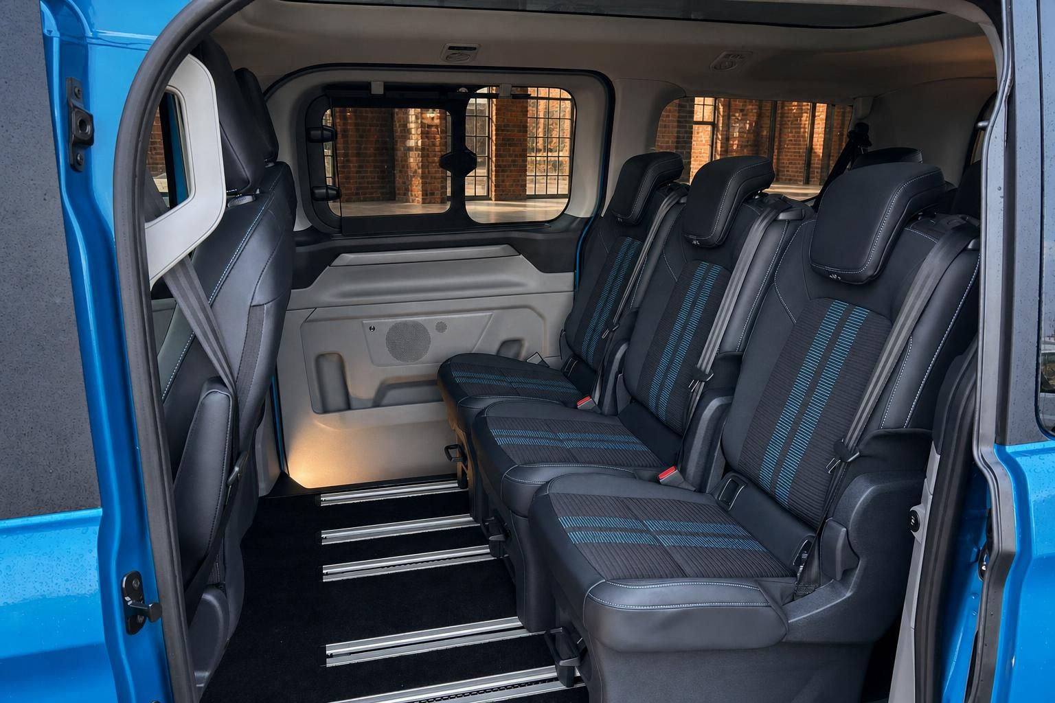 Ford Transit Innenraum mit Sitzreihen und Panoramafenster von hinten