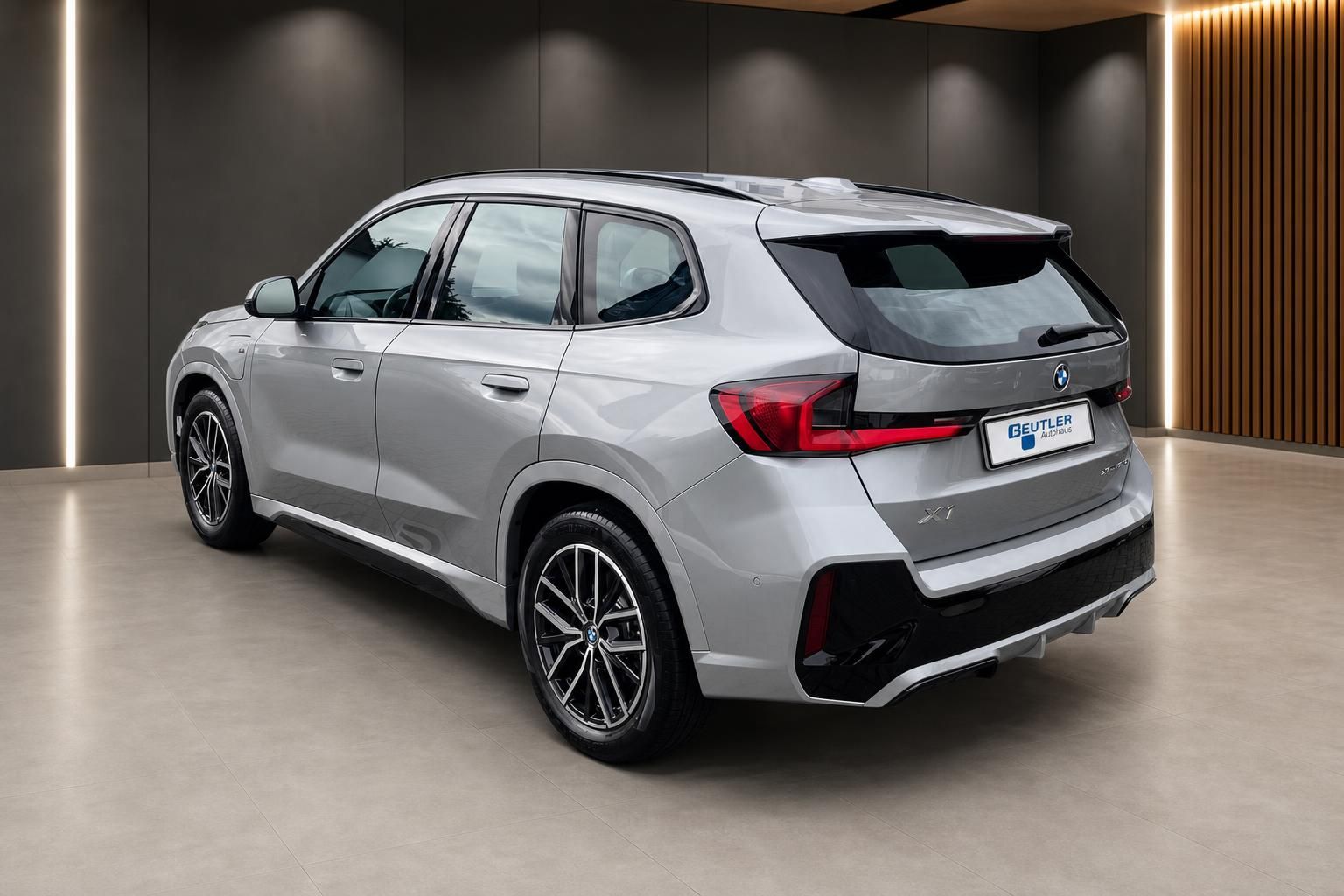 BMW X1 xDrive25e Heckansicht schraeg in Silber, M Sportpaket