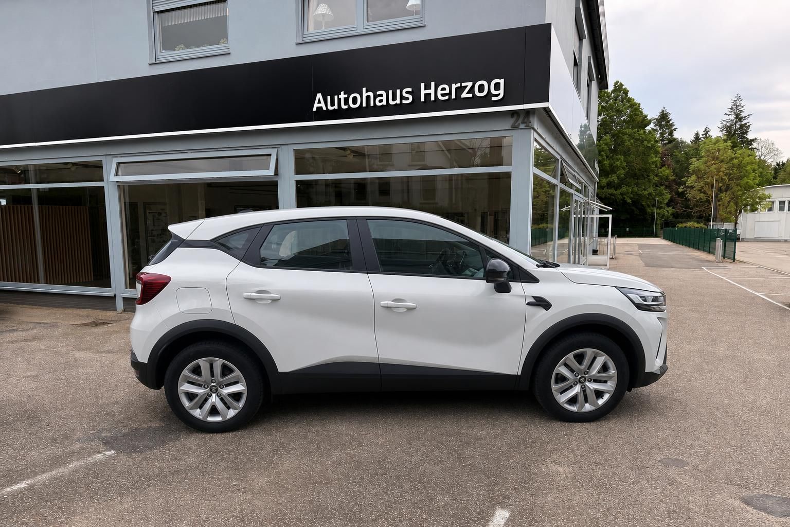 Mitsubishi SUV weiß Seitenansicht vor Autohaus Herzog Gebäude auf Parkplatz